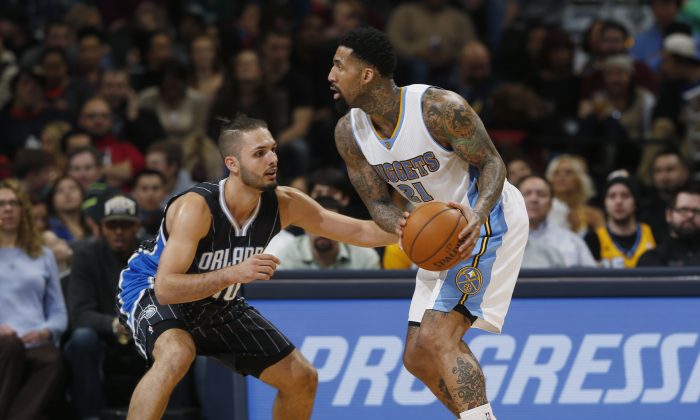 Orlando Magic guard Evan Fournier, left, of France, covers Denver Nuggets forward Wilson Chandler covers in the fourth quarter of an NBA basketball game Wednesday, Jan. 7, 2015, in Denver. (AP Photo/David Zalubowski)