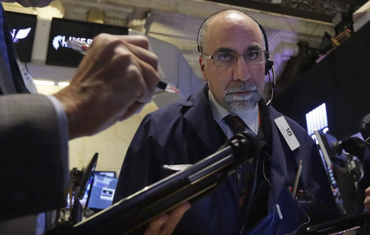 Trader John Liotti works on the floor of the New York Stock Exchange, Wednesday, Jan. 14, 2015. (AP Photo/Richard Drew)