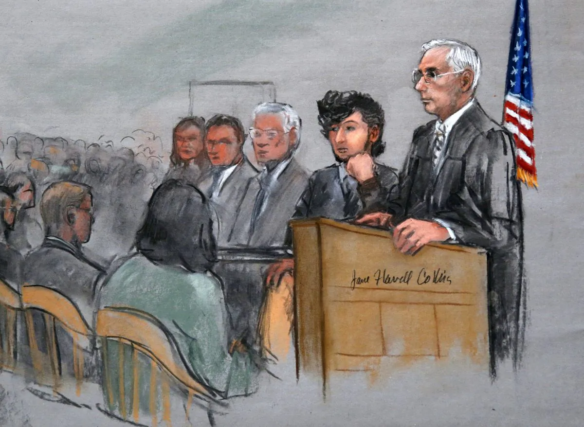 In this courtroom sketch, Boston Marathon bombing suspect Dzhokhar Tsarnaev, (2nd R), is with his lawyers and U.S. District Judge George O'Toole Jr. (AP Photo/Jane Flavell Collins) 