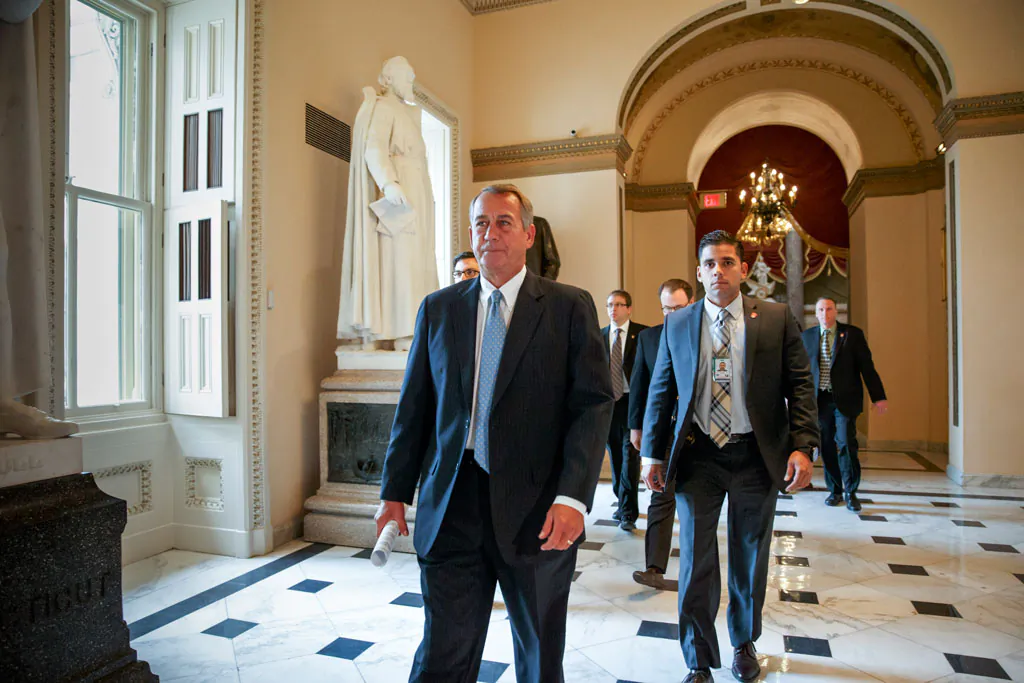 House Speaker John Boehner of Ohio, accompanied by a U.S. Capitol Police officer (R), walks to the House chamber on Capitol Hill in Washington, Wednesday, Jan. 14, 2015, as lawmakers gather for a vote to fund the Homeland Security Department but will curb President Barack Obama's executive actions on immigration. An Ohio bartender with a history of psychiatric illness was indicted on a charge of threatening to murder Boehner, possibly by poisoning his drink at a country club or shooting him, according to court documents. A grand jury indictment filed in U.S. District Court in Ohio on Jan. 7 identified the accused man as Cincinnati resident Michael R. Hoyt, said the records made available Tuesday. (AP Photo/J. Scott Applewhite)