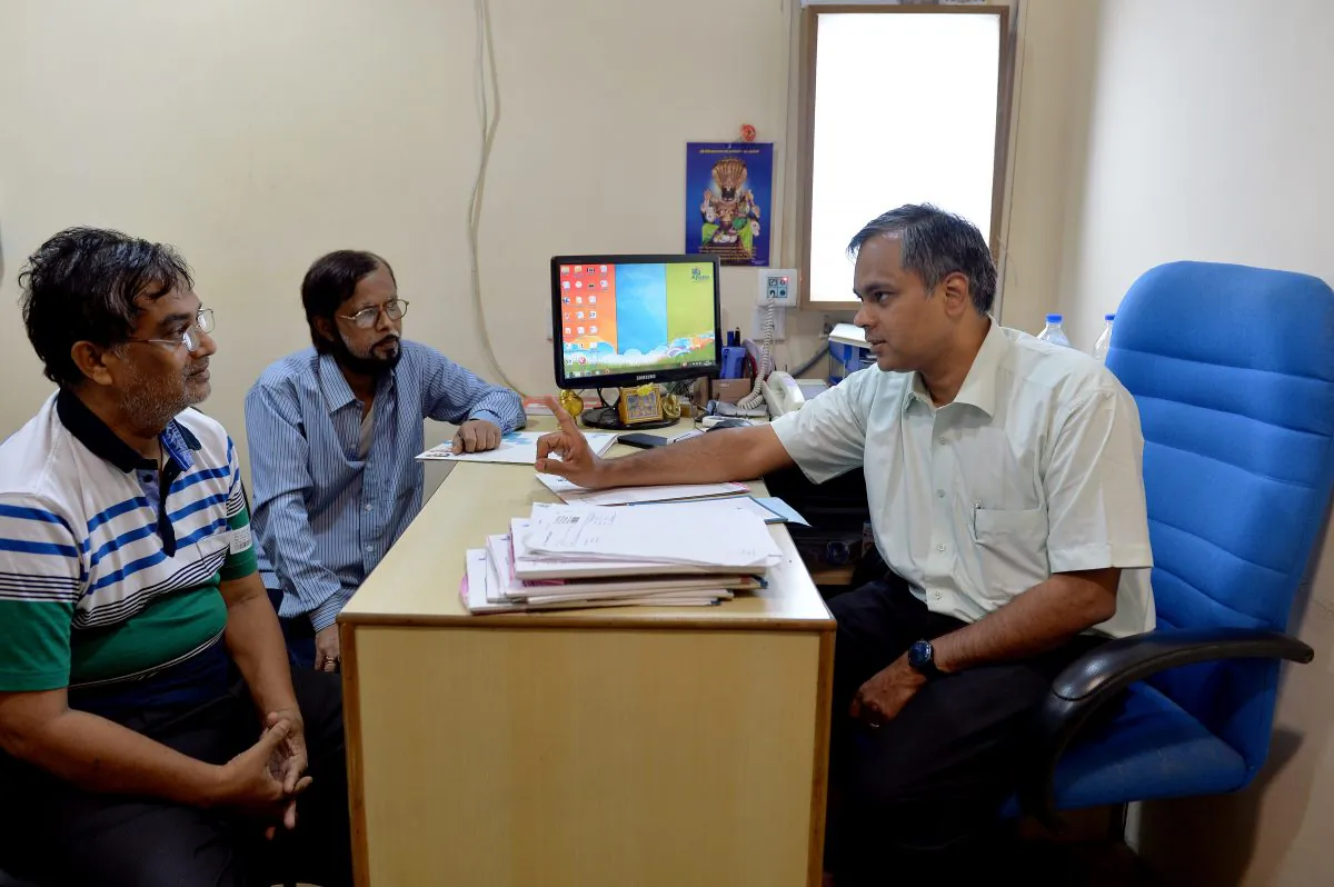 Consultant uro-oncologist and robotic surgeon N. Ragavan (R) speaks to a patient at the Apollo Hospital in Chennai, India, on March 29, 2014. In Chennai, known as India's health care capital, is developing as a top budget destination for medical tourists. (Manjunath Kiran/AFP/Getty Images)