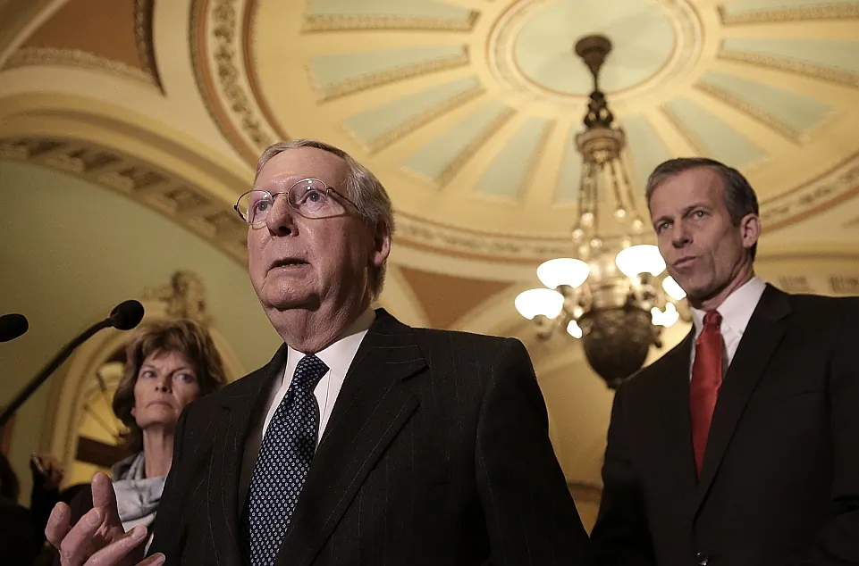 Senate Majority Leader Mitch McConnell (R-Ky.) (L) with Senate Republicans at the Capitol in Washington, D.C. on Jan. 13. McConnell wants to adjust the definition of a workweek under the ACA from 30 to 40 hours. (Win McNamee/Getty Images)