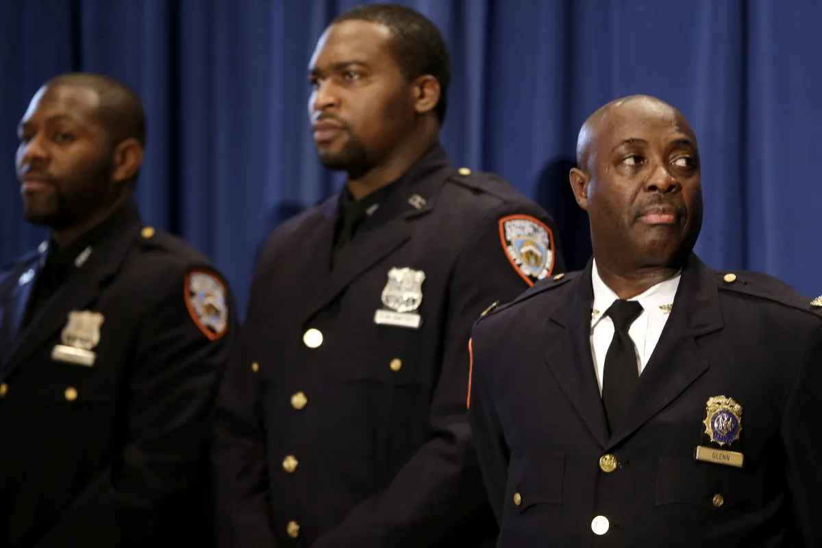 New York City Department of Correction officers at the Rikers Island jail complex, on Wednesday, Dec. 17, 2014. A recent report by the city's watchdog agency revealed that when hiring correction officers, the correction department repeatedly failed to screen for gang member affiliation, felony convictions, and other questionable backgrounds. (AP Photo/Seth Wenig)