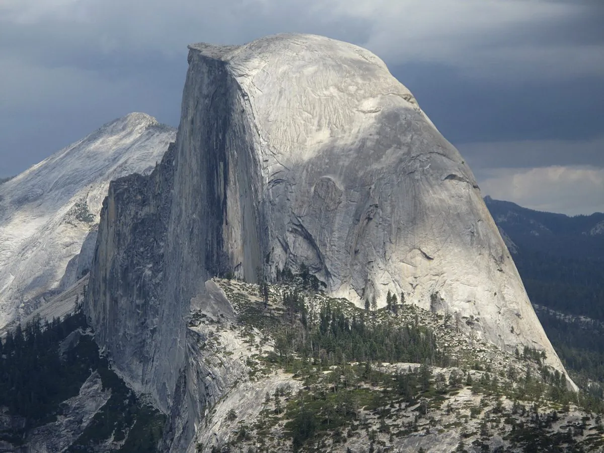 This August 2011 file photo shows Half Dome and Yosemite Valley from Glacier Point at Yosemite National Park, Calif. About six miles away, climbers Kevin Jorgeson and Tommy Caldwell are roughly halfway through an ascent of another famous Yosemite cliff: El Capitan. The free climb they are attempting on a half-mile section of exposed granite is considered one of the hardest rock climbs in the world. (AP Photo/Tracie Cone)