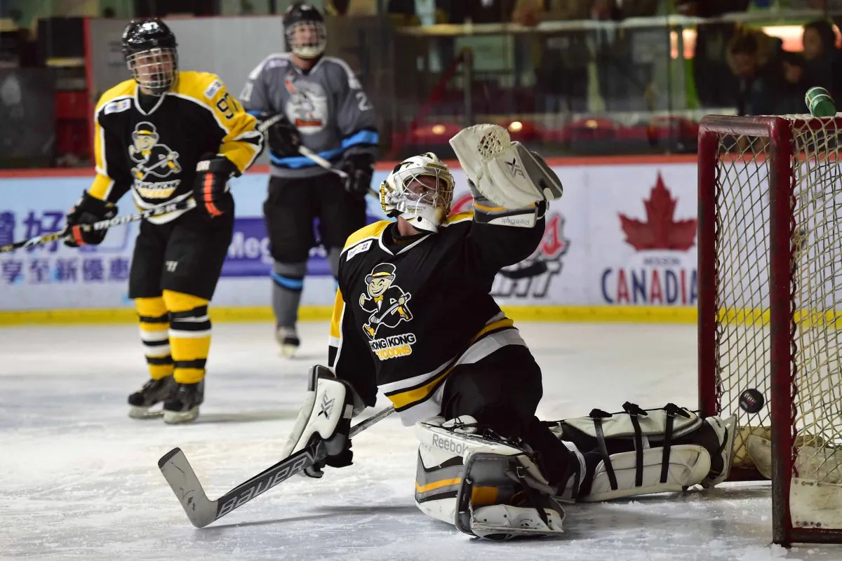 Tycoon’s goalie Cody Drumm just misses this shot from Shark attackers in their CIHL match at Mega Ice on Saturday Jan 10. (Bill Cox/Epoch Times)