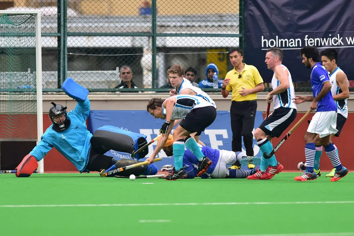 HKFC-A players scramble to get the ball away from their goal during an attack by Punjab-A in their HKHA Premier Division match at HKFC on Sunday Jan 11, 2015. (Bill Cox/Epoch Times)