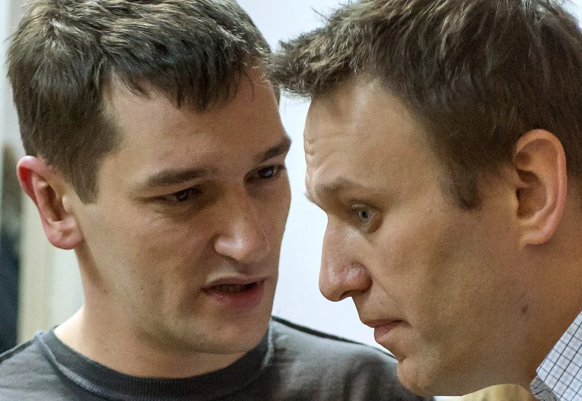 Russian anti-Kremlin opposition leader Alexei Navalny (R) and his brother and co-defendant Oleg Navalny as they attend the verdict announcement of their fraud trial at a court in Moscow on Dec. 30, 2014. (Dmitry Serebryakov/AFP/Getty Images)