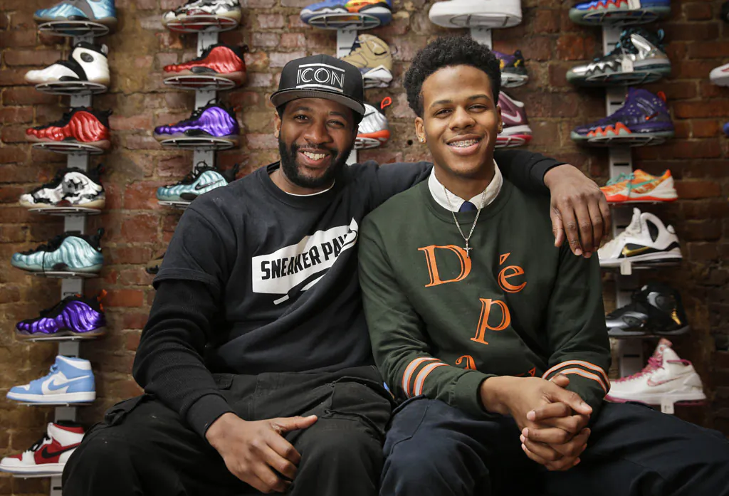 Entrepreneurs Chase Reed (R) and his father Troy Reed pose for a picture in their store in the Harlem section of New York on Jan. 12, 2015. The Reeds run Sneaker Pawn, a store that capitalizes on America’s multi-billion dollar athletic footwear market and the high prices sneakers can get being re-sold. (AP Photo/Seth Wenig)