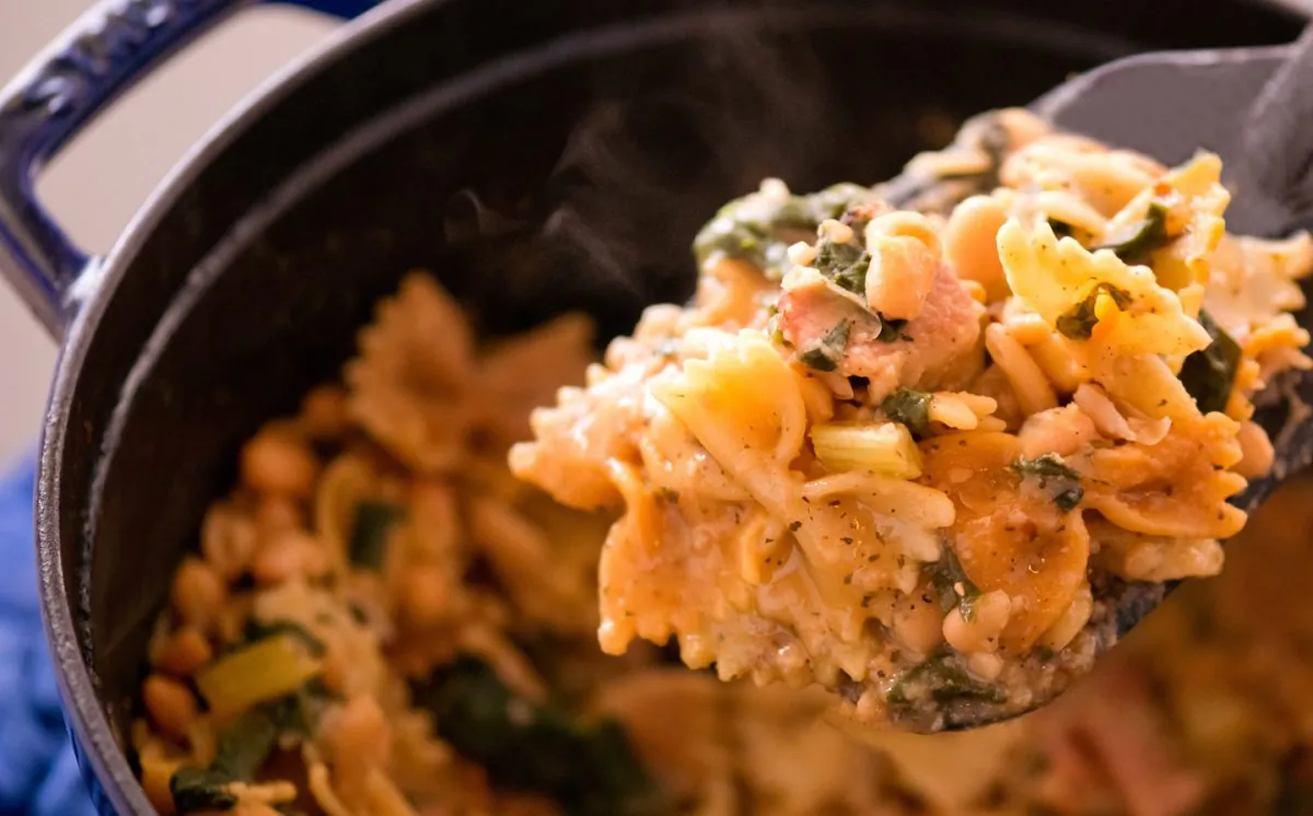 A hearty winter dish of pasta, beans, bacon, and spinach—a perfect low-budget meal for a chilly evening. (Cat Rooney)