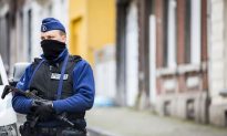 Belgium Police Arrest 21, Paris Fugitive Still at Large