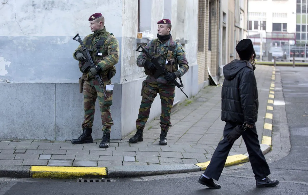Belgian para-commandos patrol near a synagogue in the center of Antwerp, Belgium, on Saturday, Jan. 17, 2015. Security around Belgium has been stepped up after thirteen people were detained in Belgium in an anti-terror sweep following a firefight in Verviers, Belgium, in which two suspected terrorists were killed. (AP Photo/Virginia Mayo)