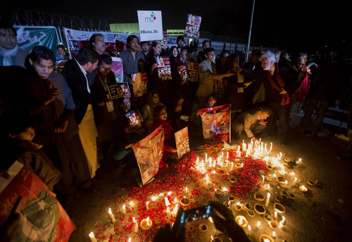 Members of Pakistan's civil society groups light candles and shout anti-Taliban slogans to condemn the militant group's attack on a military-run school in Peshawar, during a rally Friday, Jan. 16, 2015, outside the Parliament building in Islamabad, Pakistan. Civil society groups held protests in Pakistani cities a month after the terrorist attack on Peshawar's Army Public School, where 150 people, mostly children, were killed. (AP Photo/B.K. Bangash)