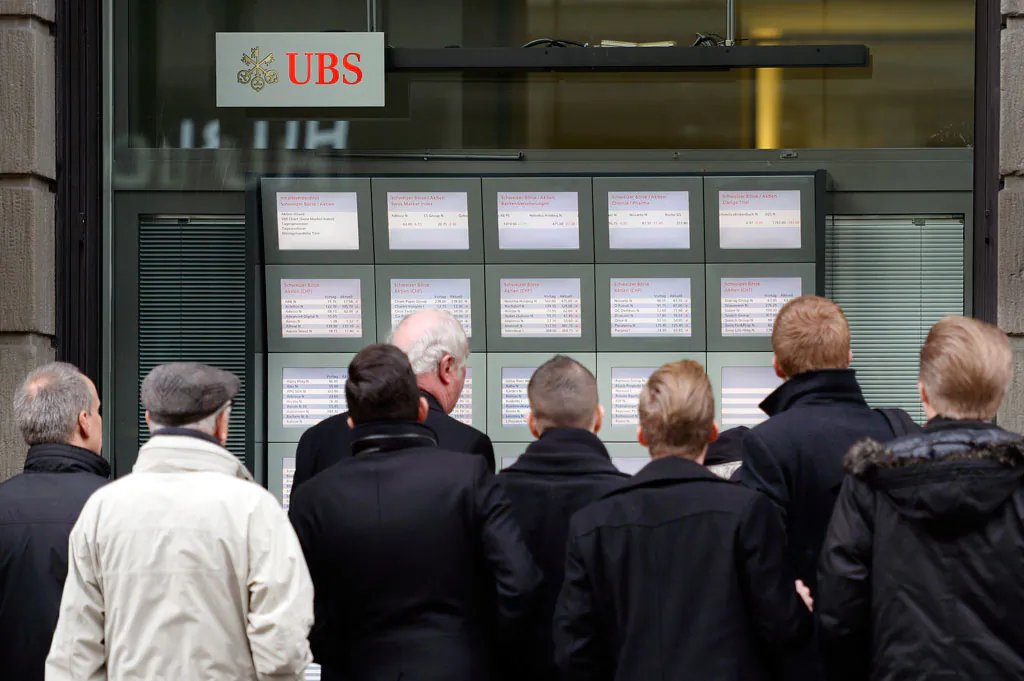 People follow turbulence on the stock exchange in Zurich, Switzerland, on Jan. 15, 2015. (AP Photo/Keystone, Walter Bieri)