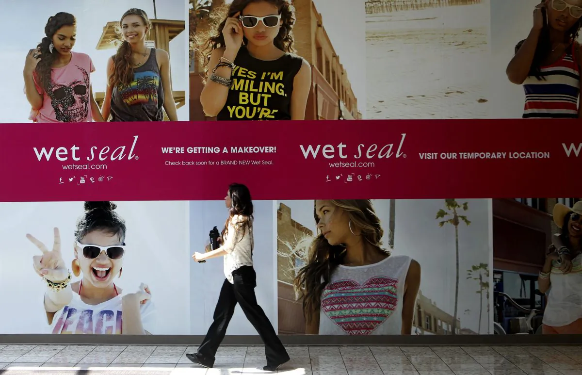 Shianne Penoli walks past the future location of Wet Seal at the Mount Shasta Mall in Redding, Calif., on July 2, 2013. Wet Seal, a teen clothing retailer, has filed for Chapter 11 bankruptcy protection, the company announced Friday, Jan. 16, 2015. (AP Photo/Record Searchlight, Greg Barnette)