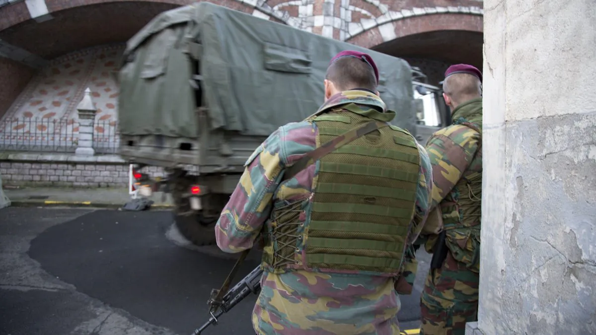 Belgian para-commandos patrol near a synagogue in the center of Antwerp, Belgium, on Saturday, Jan. 17, 2015. Security around Belgium has been stepped up after thirteen people were detained in Belgium in an anti-terror sweep following a firefight in Verviers, Belgium, in which two suspected terrorists were killed. (AP Photo/Virginia Mayo)