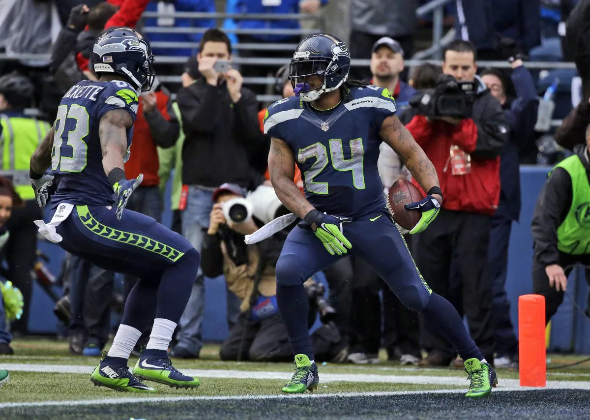 Seattle Seahawks' Marshawn Lynch (24) celebrates his touchdown run during the second half of the NFL football NFC Championship game against the Green Bay Packers Sunday, Jan. 18, 2015, in Seattle. (AP Photo/Elaine Thompson)