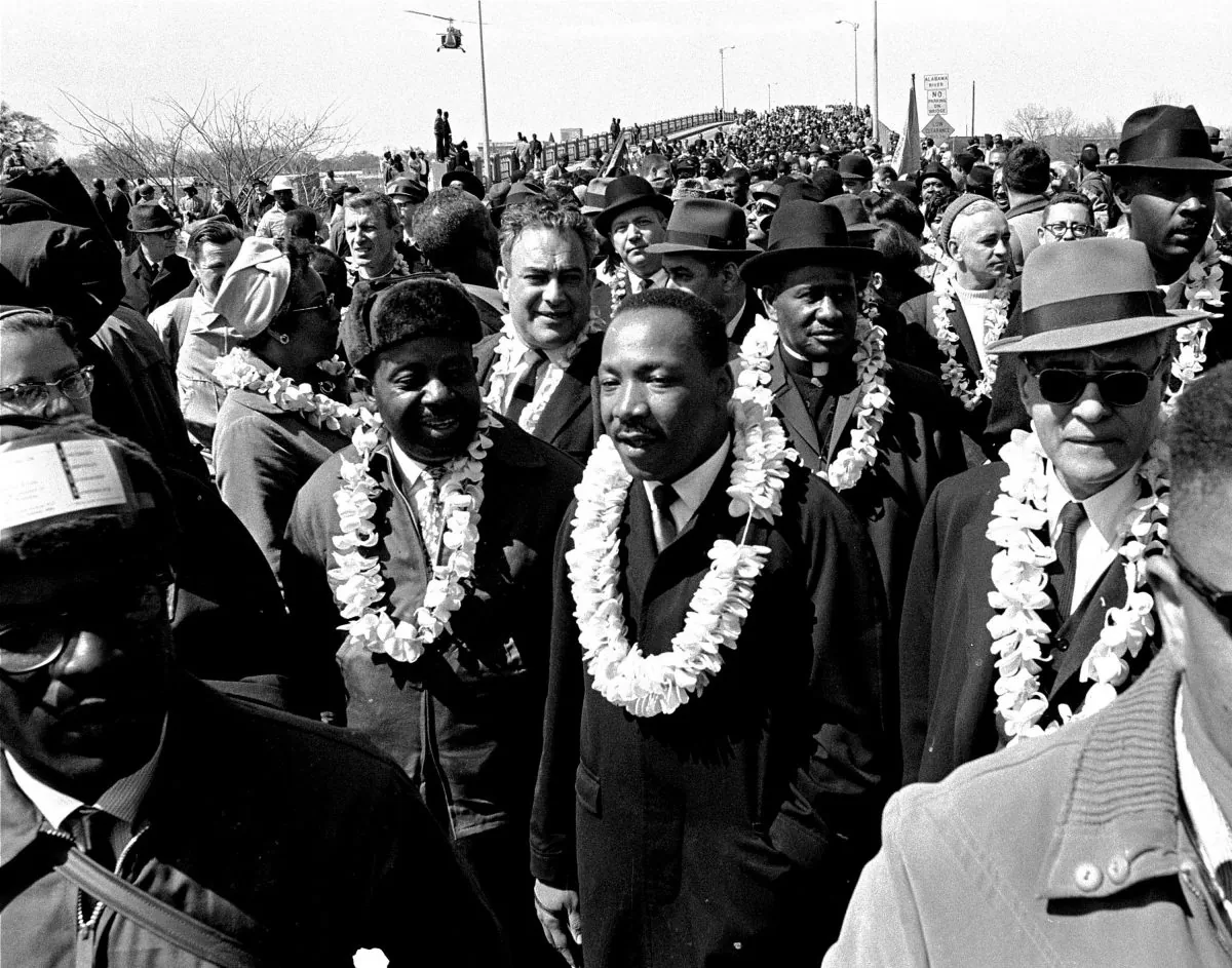 This March 21, 1965 file photo shows Martin Luther King, Jr. and his civil rights marchers crossing the Edmund Pettus Bridge in Selma, Ala., heading for the capitol in Montgomery. (AP Photo)