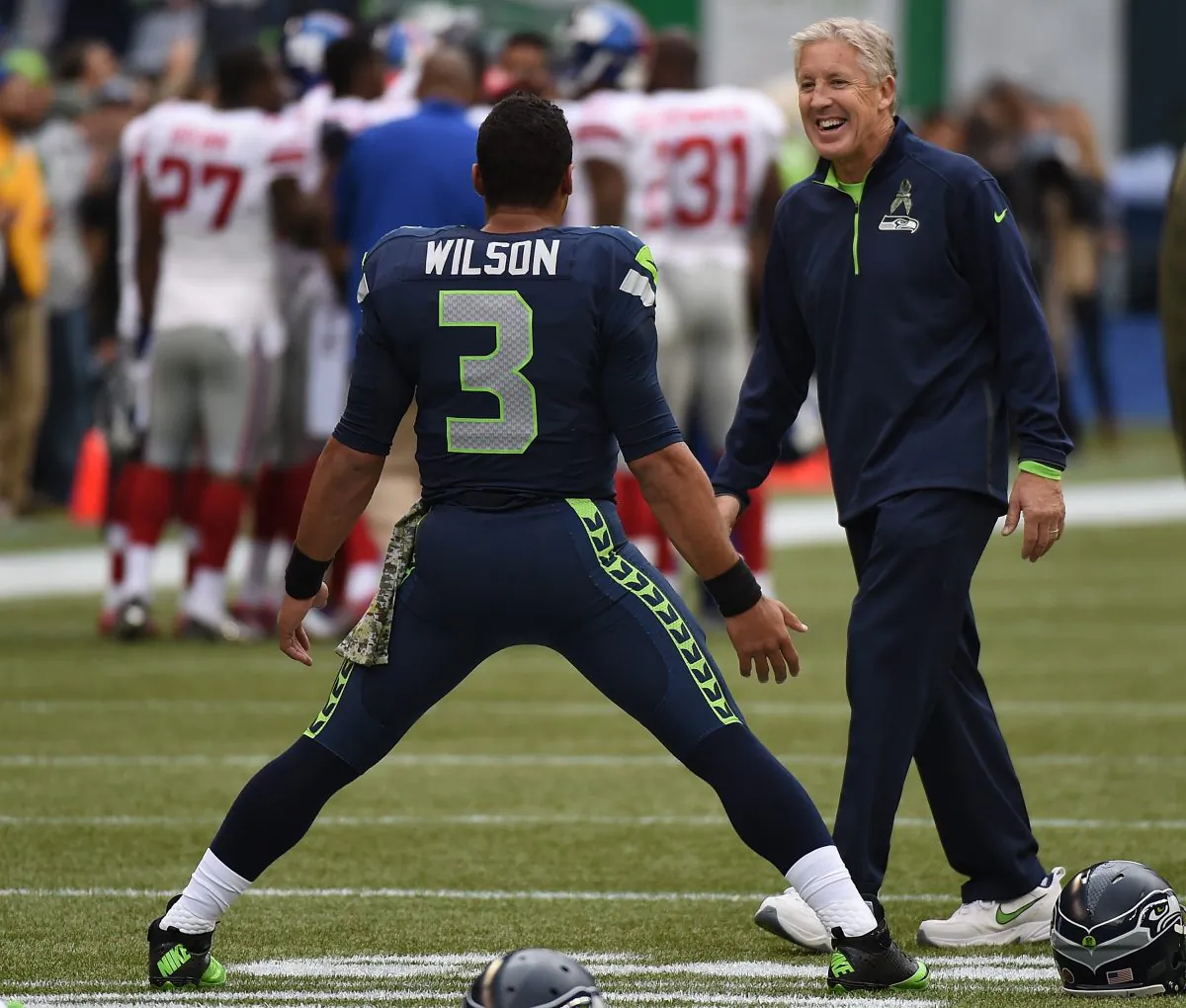 Pete Carroll chats with Russell Wilson as he warms up before the game against the New York Giants at CenturyLink Field on Nov. 9, 2014 in Seattle. (Steve Dykes/Getty Images)
