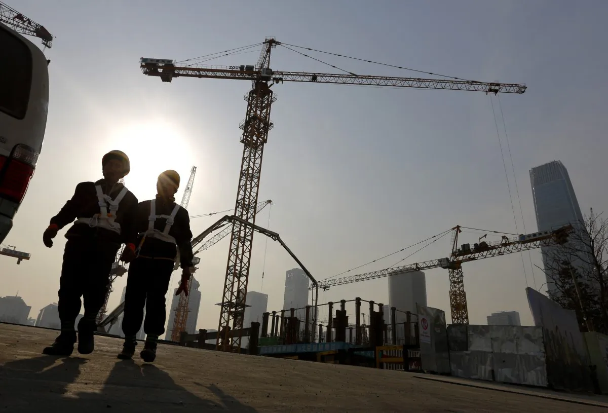 Workers walk out from a construction site at the Central Business District of Beijing on Jan. 20, 2015.
(Andy Wong/AP)