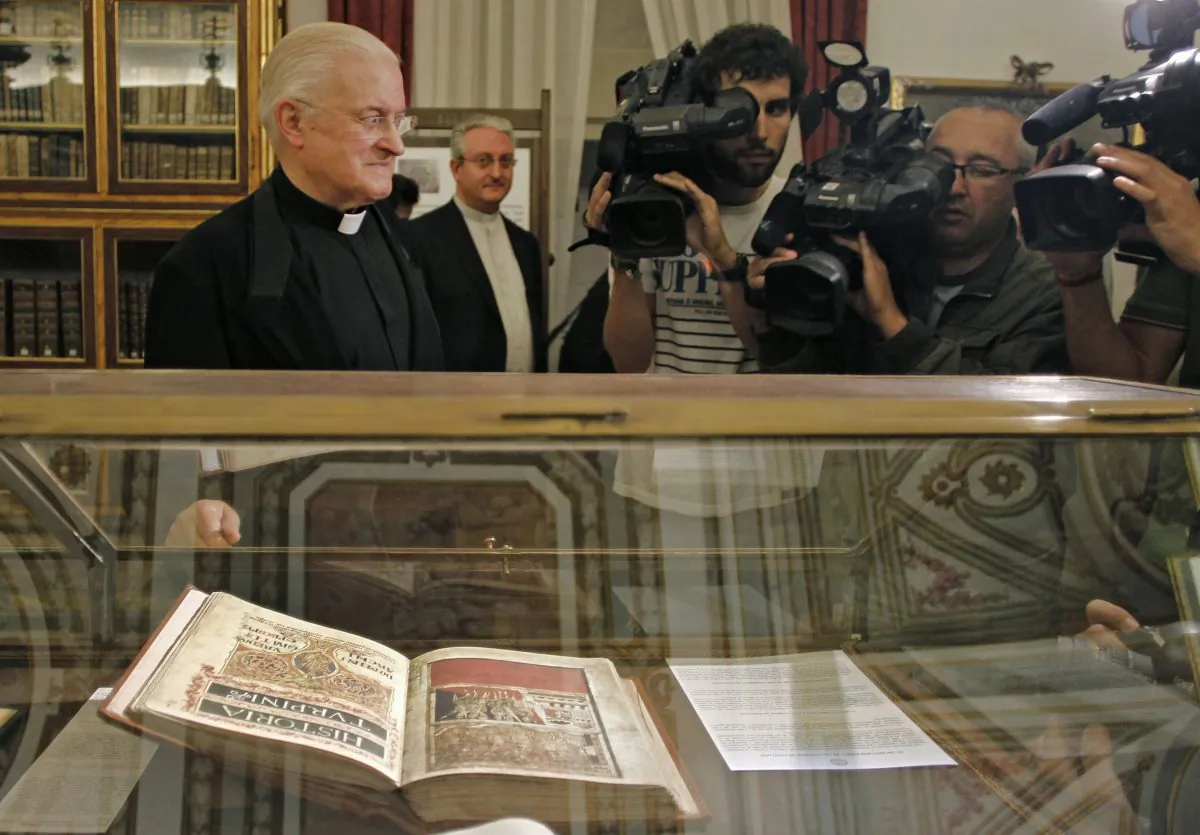 Jose Maria Diaz (R), the Dean of the Cathedral of Santiago de Compostela, poses by a replica of the 12th century religious Calixtinus Codex manuscript on display in the cathedral on July 7, 2011. A former electrician for Spain’s famed cathedral in Santiago de Compostela is on trial for his alleged theft of the priceless 12th-century Codex Calixtinus religious manuscript. It is considered the first guide for Christians making the ancient pilgrimage across northern Spain called the Camino de Santiago. Jose Manuel Fernandez Castineiras appeared in court Monday Jan. 19, 2015 with his wife and son after authorities found the Codex in his garage in 2011 and recovered 1.2 million euros ($1.4 million). (AP Photo)