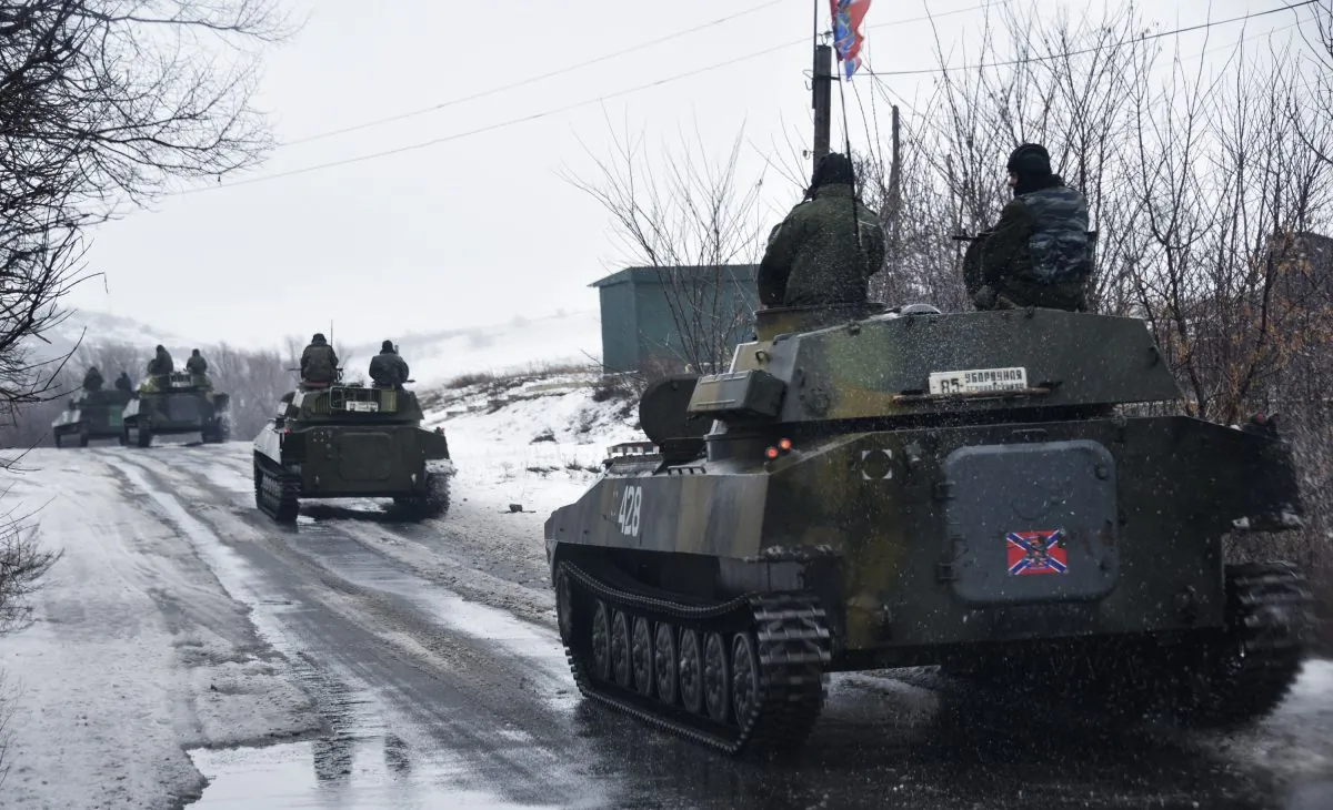 A pro-Russian armored vehicle moves toward Slovyanoserbsk, eastern Ukraine, Wednesday, Jan. 21, 2015. Moscow has proposed restoring a previously agreed line of division in eastern Ukraine to end an escalation of fighting near Donetsk, and has secured rebel agreement to pull back heavy weapons behind it, Russian foreign minister said Wednesday. (AP Photo/Mstyslav Chernov)