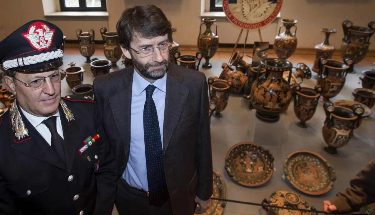 Carabinieri Gen. Mariano Mossa (L) and Italian Culture minister Dario Franceschini pose for photographers near Antiquities recovered by Italian Carabinieri, military police, are displayed at Terme di Diocleziano museum during a press conference in Rome, Wednesday, Jan. 21, 2015. Italian authorities have unveiled what they said was a record haul of rare antiquities illegally looted from Italy and discovered during raids on Swiss warehouses belonging to an accused Sicilian art dealer. The carabinieri police's art squad estimated the value of the 5,361 vases, kraters, bronze statues and frescoes at some 50 million euros. The works, from the 8th century B.C. to the 3rd century A.D., were laid out Wednesday at the National Roman Museum and may go on public display. Carabineri Gen. Mariano Mossa said it was "by a long shot the biggest recovery in history in terms of the quantity and quality of archaeological treasures." They were found during an investigation into Basel-based art dealer Gianfranco Becchina, accused by prosecutors of being part of a huge trafficking network. (AP Photo/Claudio Peri, Ansa)