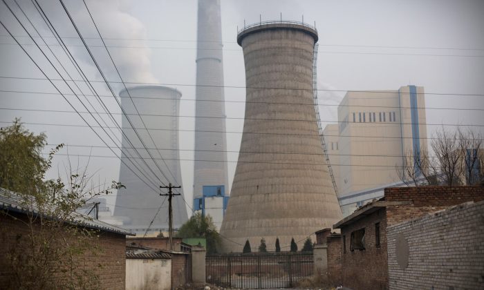 Smoke billows from a coal-fired power plant in Beijing, China on Nov. 19. 2014. (Kevin Frayer/Getty Images)