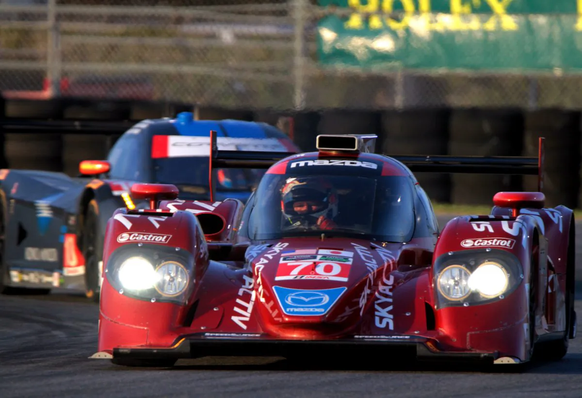 SpeedSource owner/driver Sylvain Tremblay in the #70 Mazda diesel leads the #10 WTR Dallara-Corvette around a corner at Daytona, Jan. 10, 2015. (Chris Jasurek/Epoch Times)