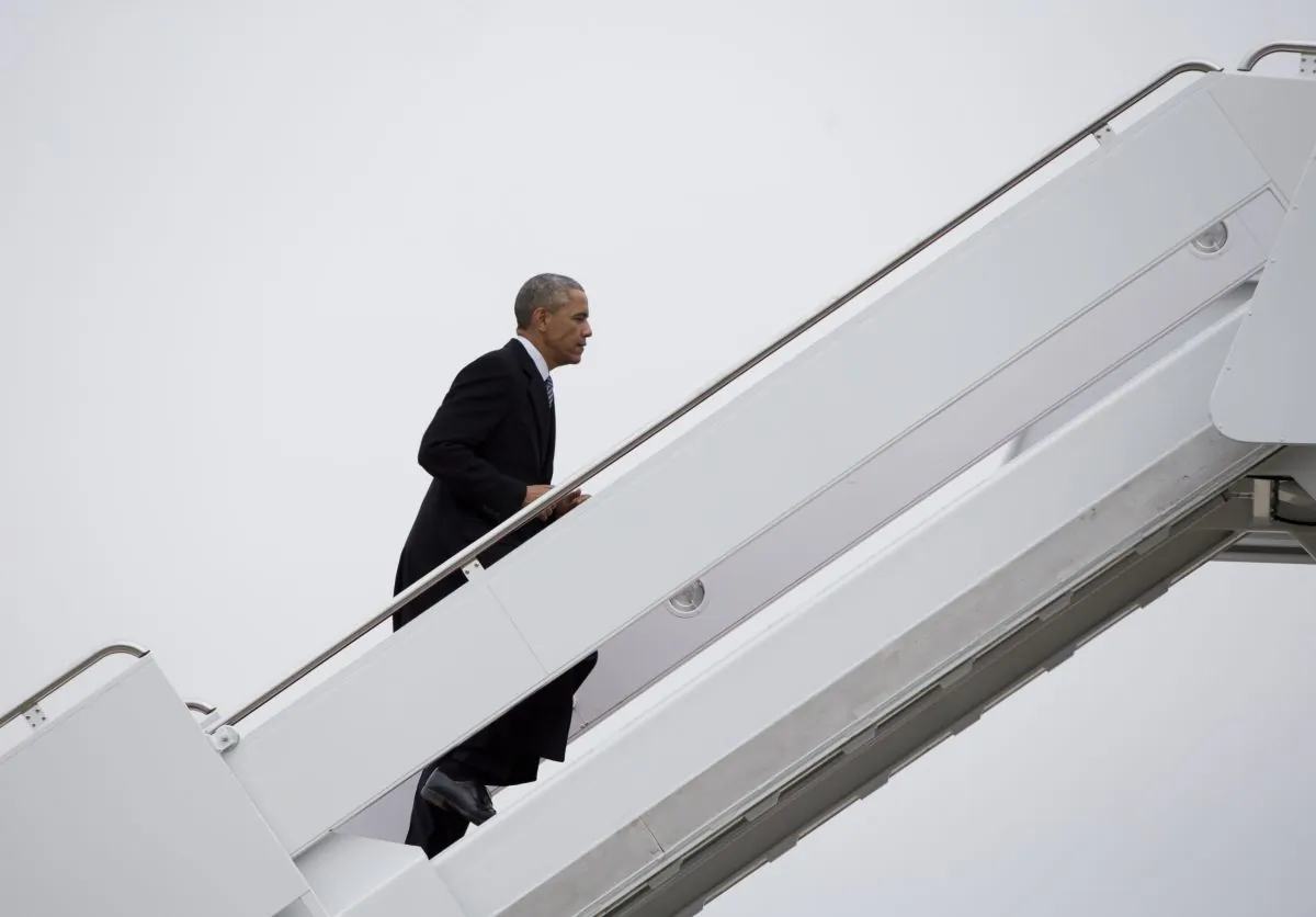 President Barack Obama boards Air Force One, Wednesday, Jan. 21, 2015, at Andrews Air Force Base, Md., en route to Boise State University where he will discuss the themes in his State of the Union address. (AP Photo/Carolyn Kaster)