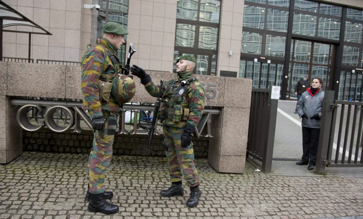 Two soldier from the Belgian military stand guard in front of EU headquarters in Brussels on Wednesday, Jan. 21, 2015. Security around Belgium has been stepped up and the military deployed to various high profile sites to guard against potential terror attacks. (AP Photo/Virginia Mayo)