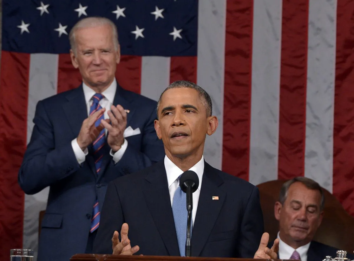 President Barack Obama delivers his State of the Union address to a joint session of Congress on Capitol Hill on Jan. 20, 2015, in Washington, as Vice President Joe Biden applauds and House Speaker John Boehner of Ohio, listens. (AP Photo/Mandel Ngan)