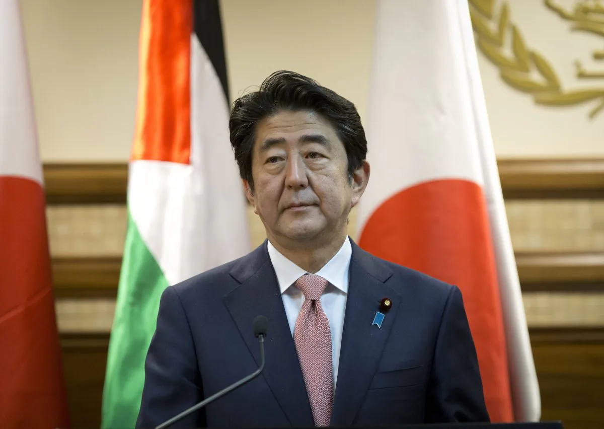 Japanese Prime Minister Shinzo Abe attends a joint press conference with Palestinian President Mahmoud Abbas at the Palestinian Authority headquarters, in the West Bank city of Ramallah, Tuesday, Jan. 20, 2015. An online video released Tuesday purported to show the Islamic State group threatening to kill two Japanese hostages unless they receive a $200 million ransom in the next 72 hours. (AP Photo/Nasser Nasser)
