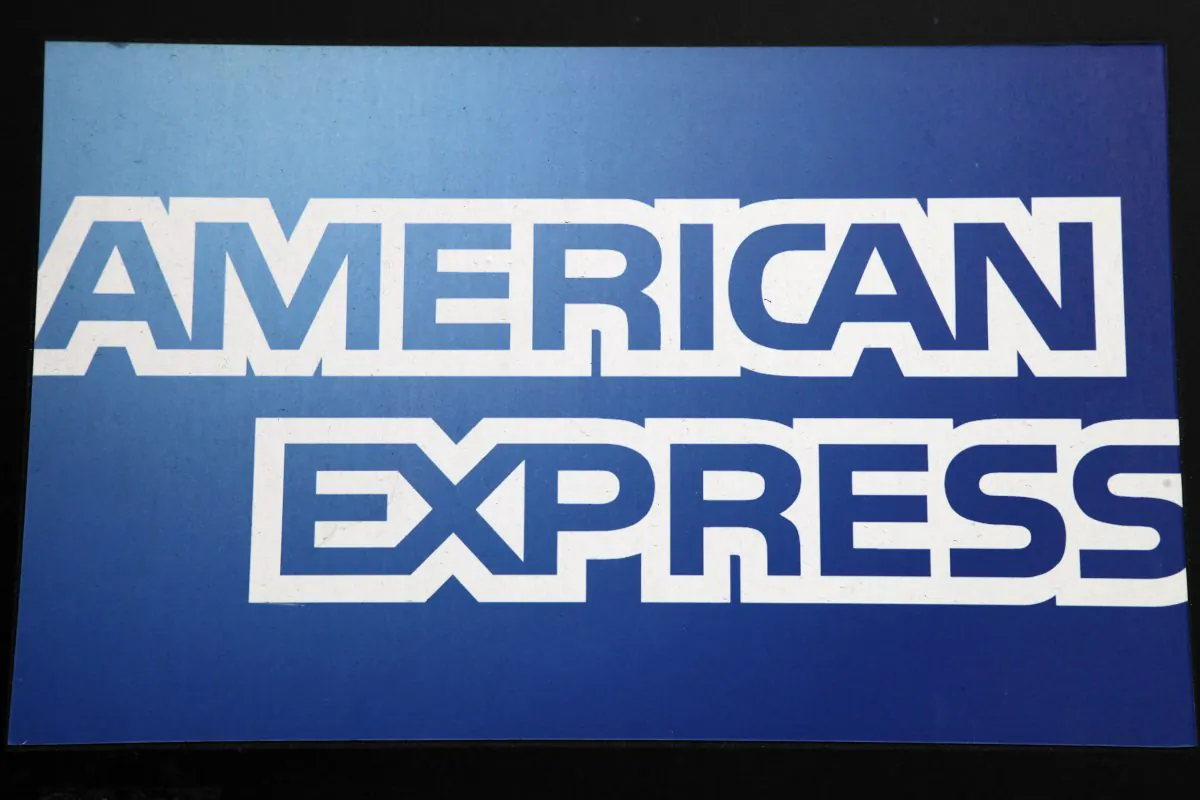 A sign for American Express hangs outside a New York business, Wednesday, Jan. 21, 2015. American Express reports quarterly financial results after the market closes on Wednesday. (AP Photo/Mark Lennihan)