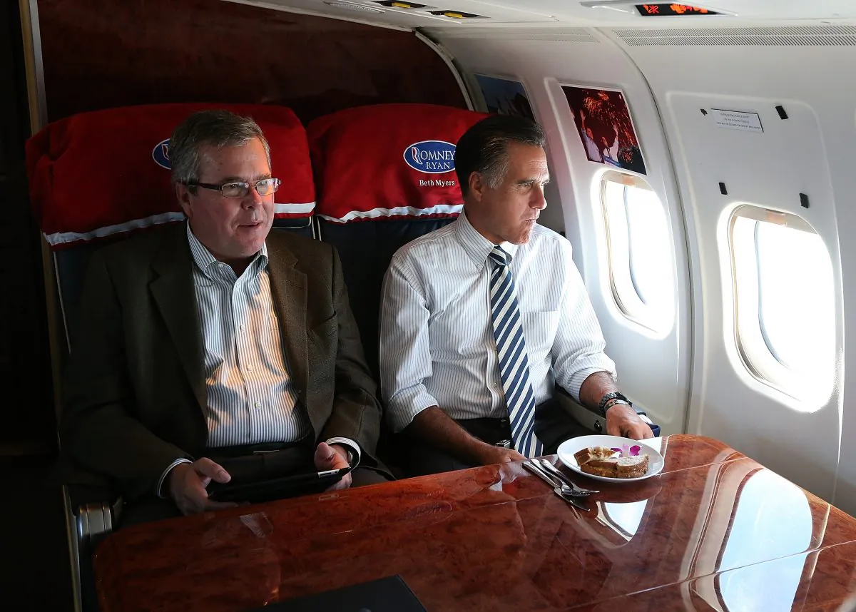Then Republican presidential candidate Mitt Romney (R) sits with former Florida Gov. Jeb Bush aboard his campaign plane on Oct. 31, 2012, en route to a campaign stop in Miami, Florida. (Justin Sullivan/Getty Images)