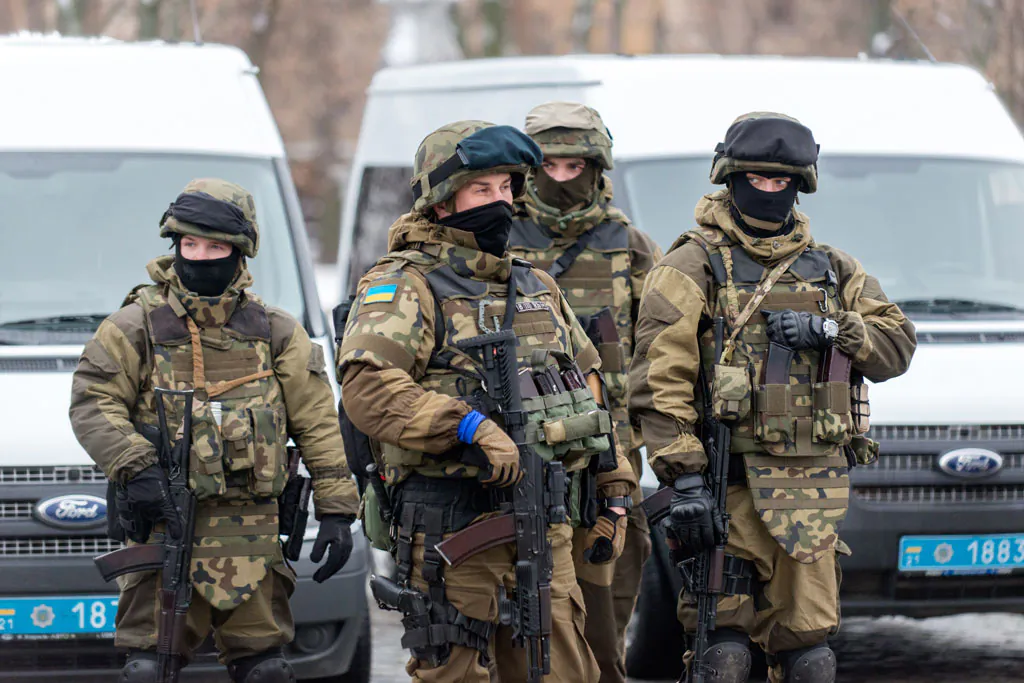 Servicemen of police units and the National Guard of Ukraine stay on the line by their armored cars during the parade prior to the first patrolling in the strengthened mode in northeastern Ukrainian city of Kharkiv on Jan. 22, 2015. The security forces will be on duty in the emergency mode to prevent frequent acts of terrorism in the city last time. (Sergey Bobok/AFP/Getty Images)