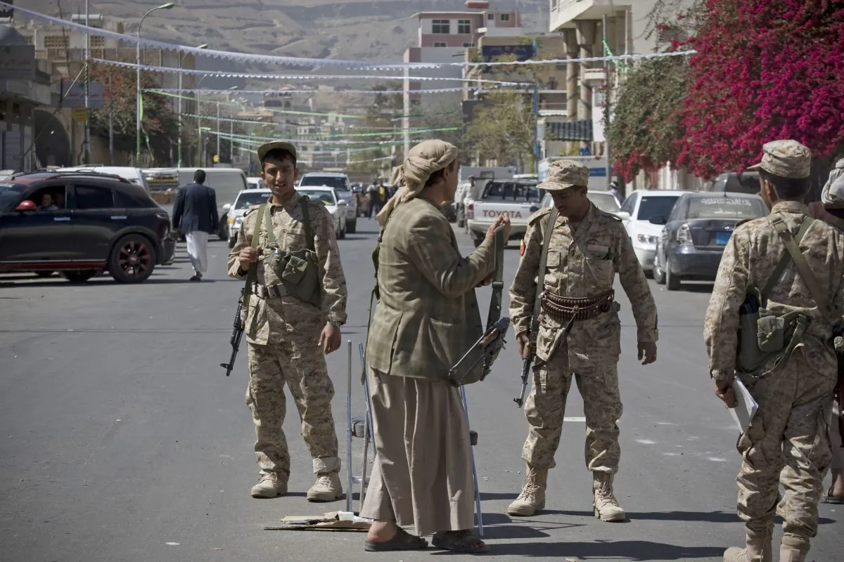 Houthi Shiite Yemeni wearing army uniforms stand guard on a street leading to the presidential palace in Sanaa, Yemen, Wednesday, Jan. 21, 2015. Authorities in southern Yemen have closed the country's second-largest airport there in protest over the Shiite rebels' power grab in the capital, Sanaa, which has plunged the nation deeper into chaos and threatens to fracture the country. (AP Photo/Hani Mohammed)