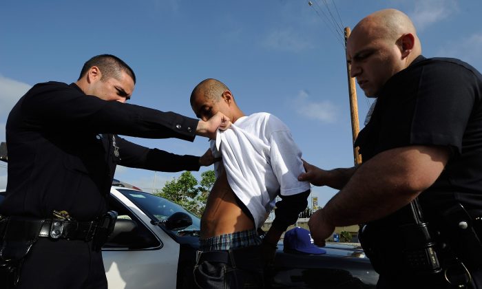 Los Angeles Police Department officers detain a twenty-year old "Street Villains" gang member on April 29, 2012. (Kevork Djansezian/Getty Images)