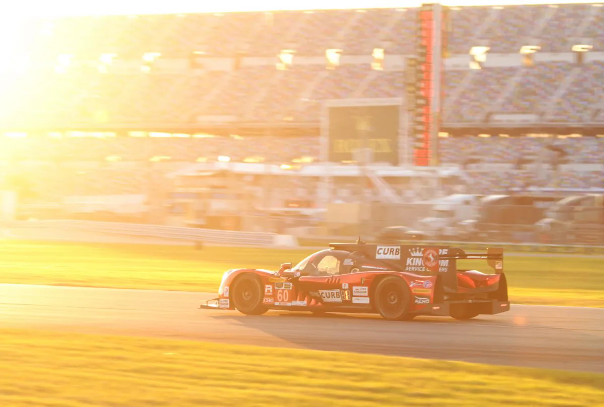 Oz Negri in the #60 Michael Shank Racing Ligier-Honda drives into the glare of the setting sun on his way to qualifying fastest for the 2015 Tudor United SportsCar Championship Rolex 24 at Daytona. (Chris Jasurek/Epoch Times)