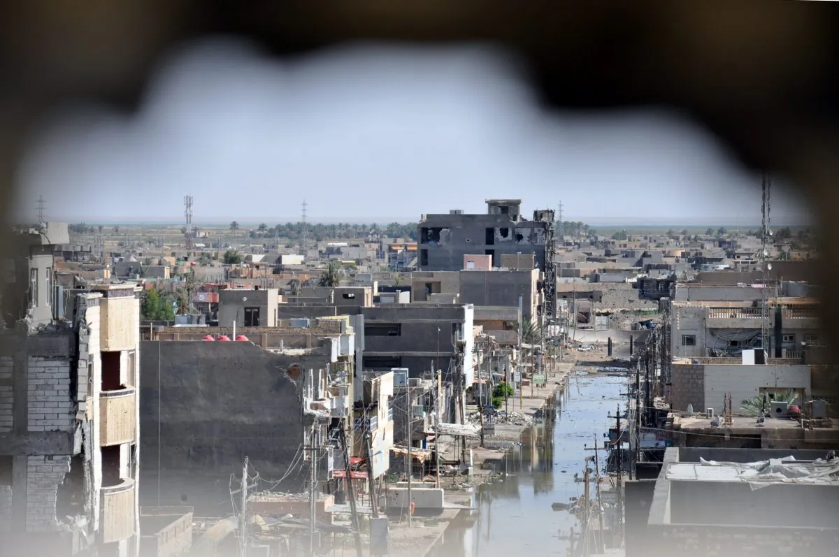 A picture taken through a hole in a wall on June 24, 2014 in the city of Ramadi in the Anbar province, shows buildings that were damaged during fighting between government forces including fighters of the Sunni anti-Al-Qaeda militia Sahwa (Awakening) and anti-government militants, including those from the jihadist Islamic State of Iraq and the Levant (ISIL). (AFP/Getty Images)