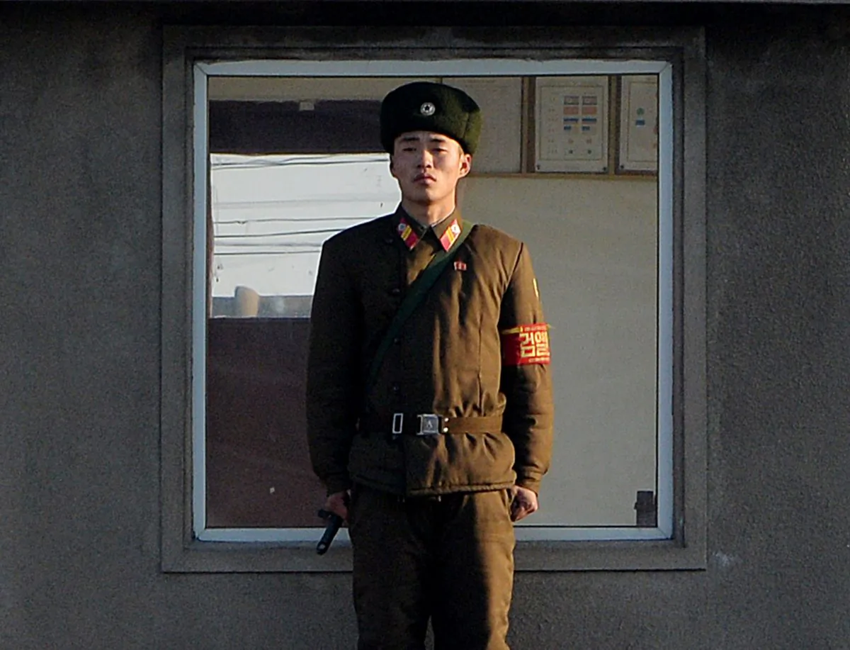A North Korea soldier stands guard on the banks of the Yalu River which separates the North Korean town of Sinuiju from the Chinese border town of Dandong on Dec. 17, 2013. On Dec. 27, 2014 a North Korean soldier crossed the border into China and killed four Chinese villagers, apparently while seeking food. (Mark Ralston/AFP/Getty Images)