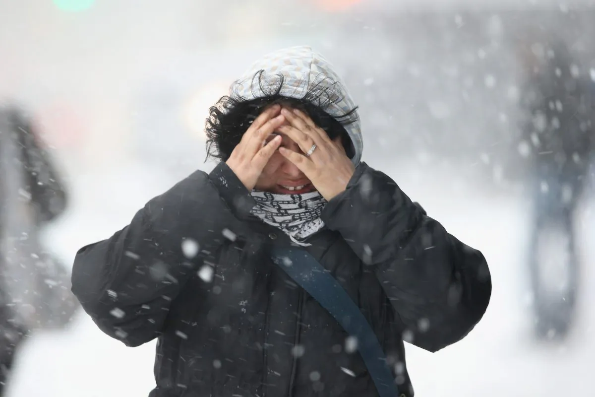 A woman covers her face while walking through the snow in New York City on Feb. 13. New York is expecting up to 3 feet of snow by late night, Jan. 27, 2015. (John Moore/Getty Images)