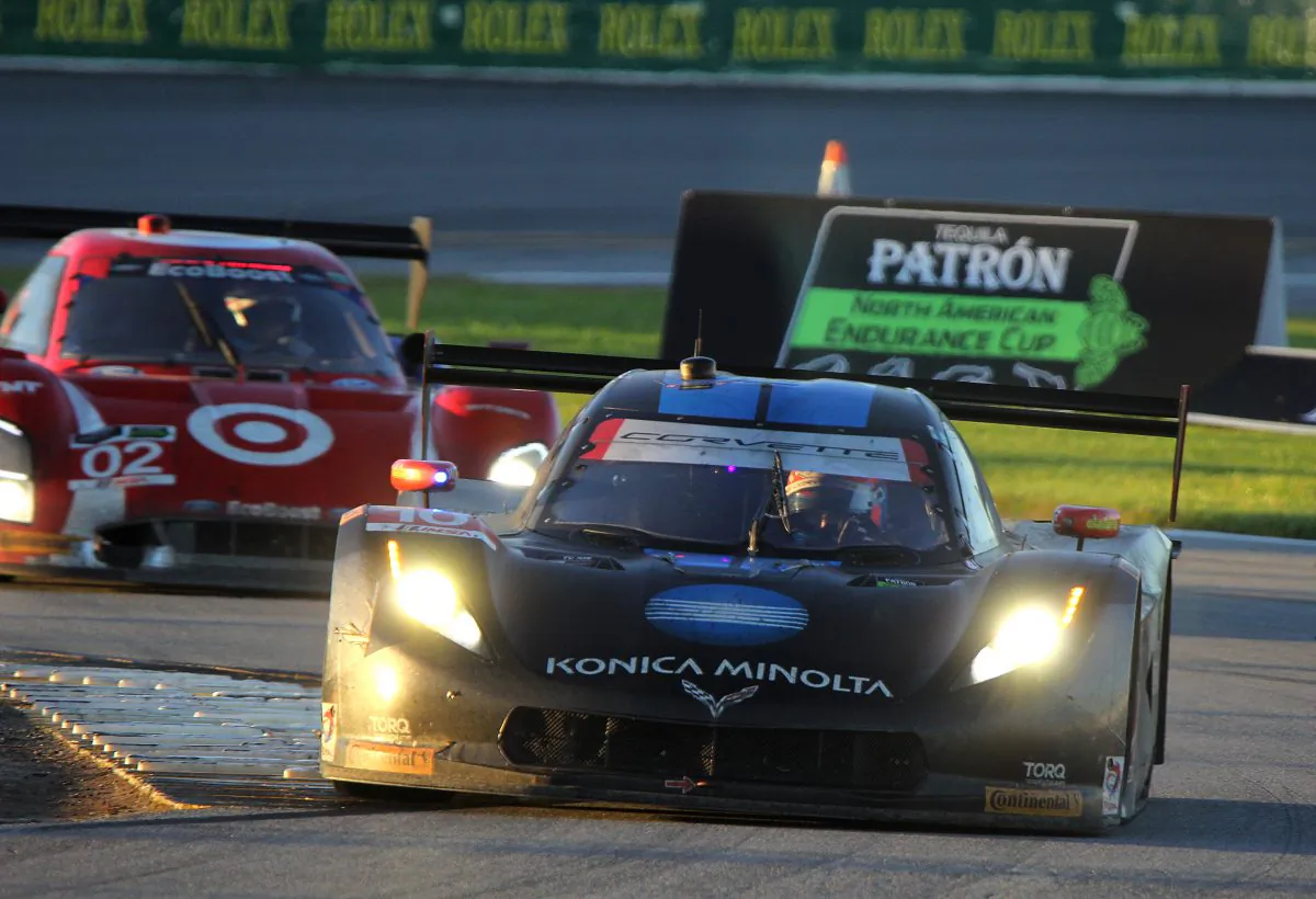 Max Angelelli in the #10 WTR Dallara-Corvette leads Tony Kanaan in the #02 Ganassi Riley-Ford Ecoboost through the Bus Stop as the Rolex 24 edges towards the finish. (Chris Jasurek/Epoch Times)