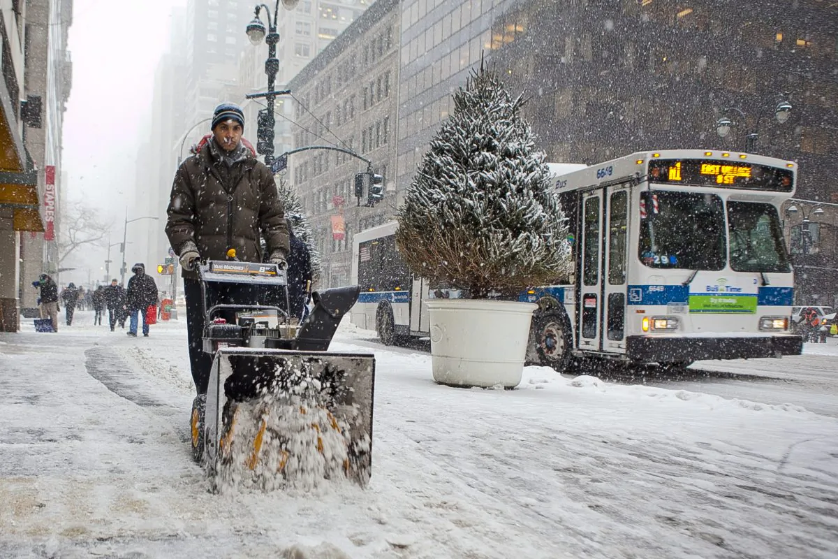A man plowing on a street in Manhattan, New York City, on Jan. 21, 2014. A winter storm bringing up to two feet of snow will descend upon New York City and the Northeastern region Monday until Wednesday. (Samira Bouaou/Epoch Times)