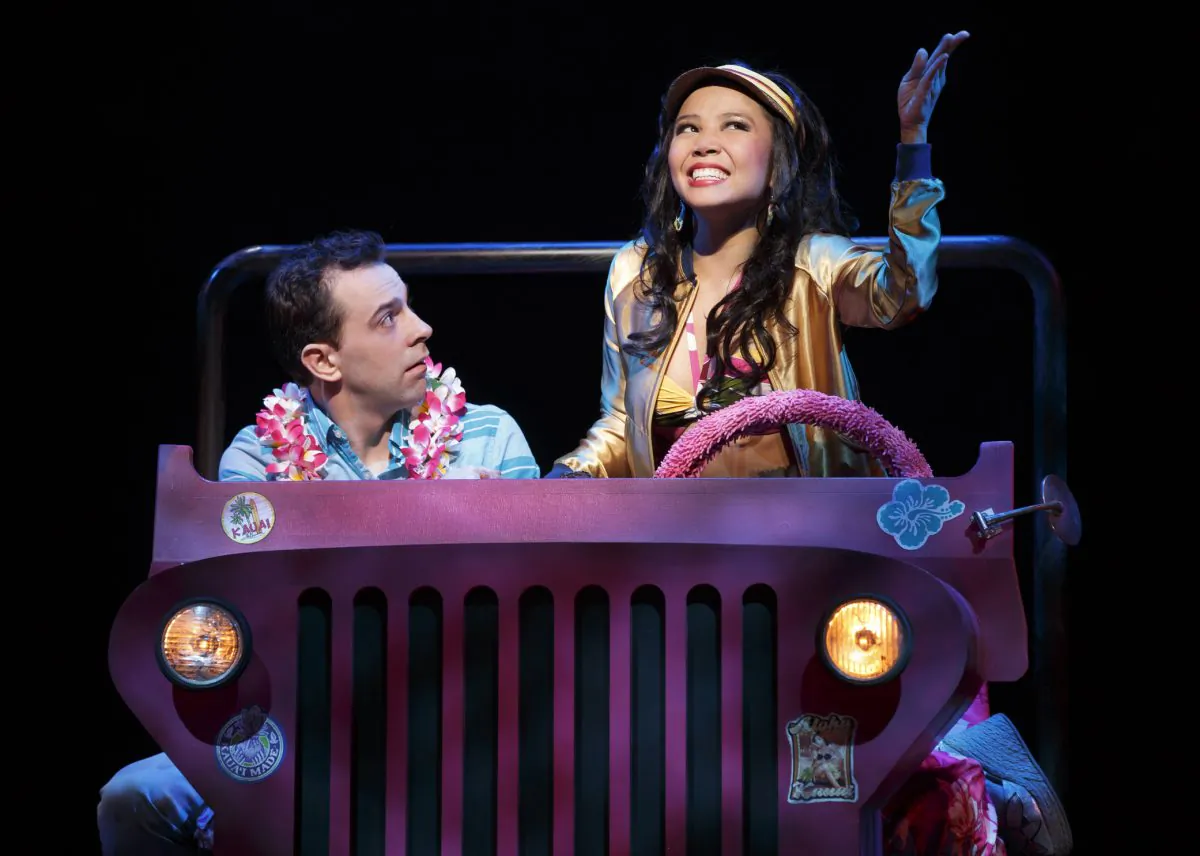 Rob McClure stars in the very funny if over the top musical “Honeymoon in Vegas.” Here Catherine Ricafort plays a Hawaiian tour guide who tries to seduce him. (AP Photo/Boneau/Bryan-Brown; Joan Marcus)