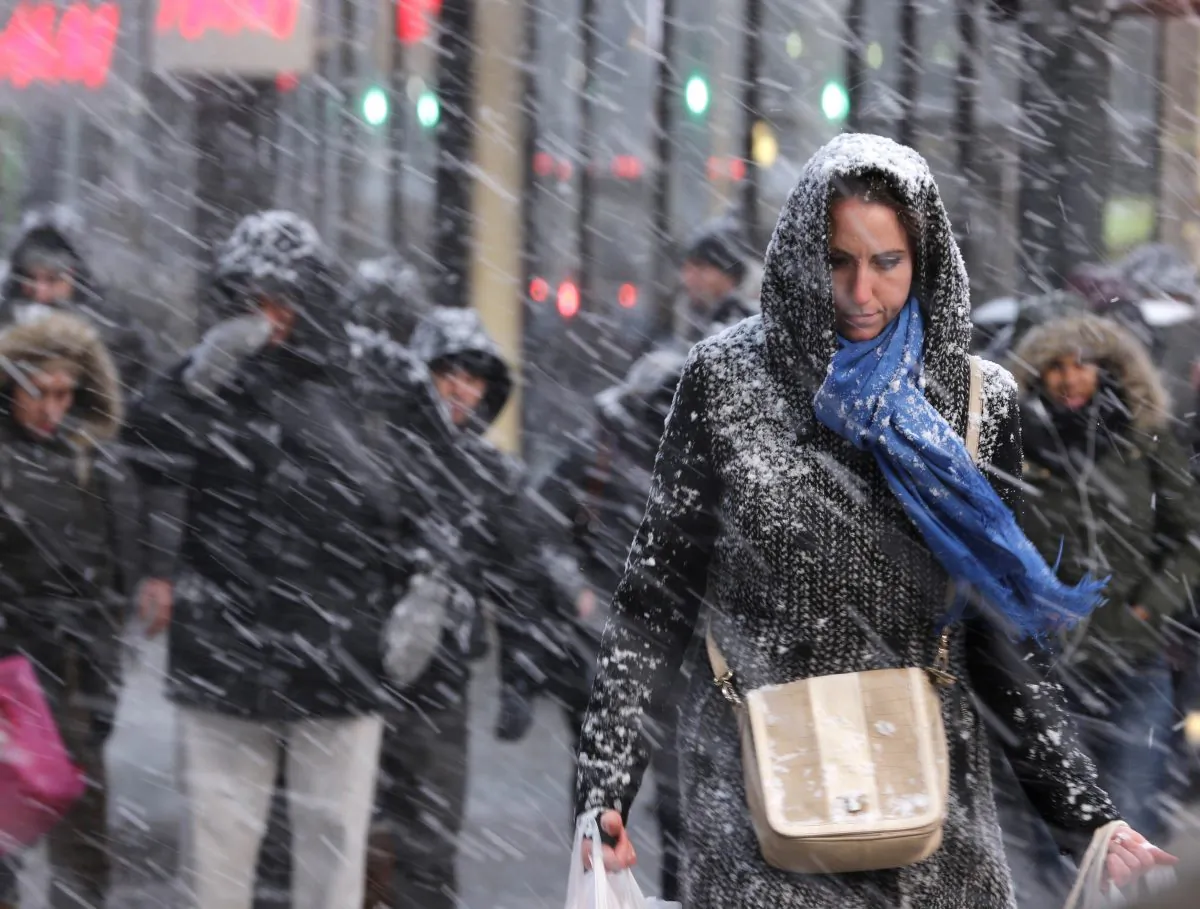 Pedestrians make their way through snow in New York, Monday, Jan. 26, 2015. (AP Photo/Seth Wenig)