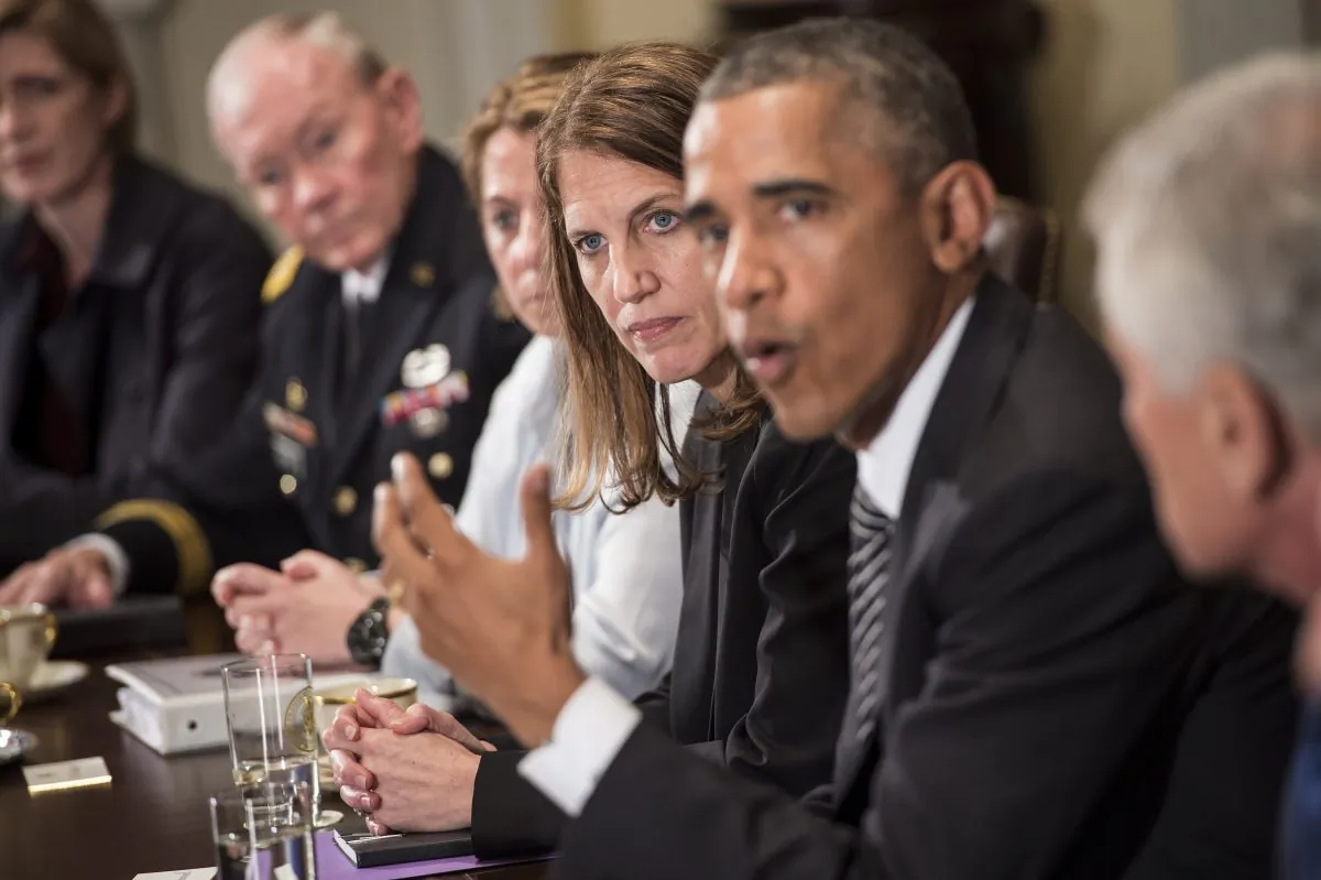 In this file photo, Sylvia Burwell (3R), Secretary of the Department of Health and Human Services, listens as US President Barack Obama (2R) makes a statement for the press after a meeting in the Cabinet Room of the White House October 15, 2014 in Washington, DC. (Brendan Smialowski/AFP/Getty Images)