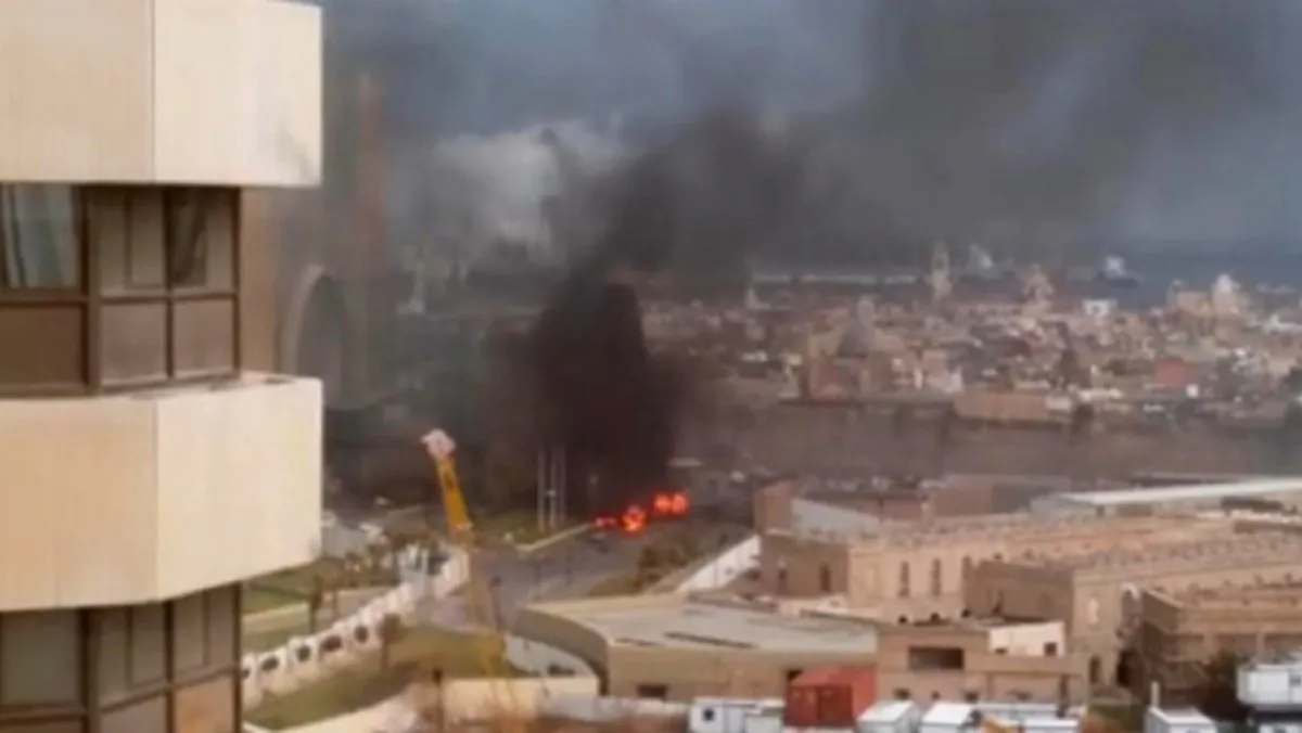In this image made from video posted by a Libyan blogger, the Cortinthia Hotel is seen under attack in Tripoli, Libya,  Tuesday, Jan. 27, 2015. (AP Photo/ @AliTweel via AP video)