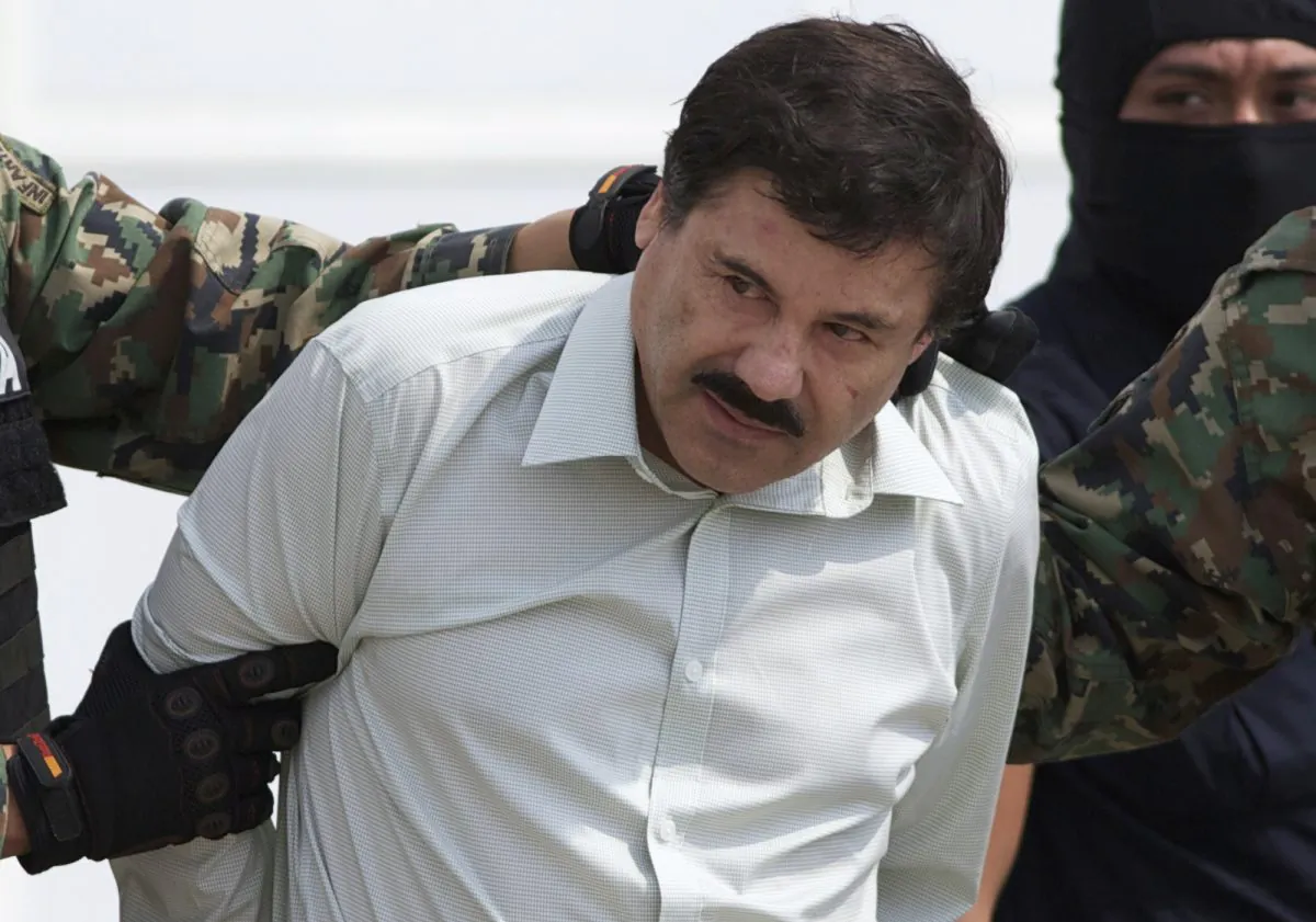 Joaquin "El Chapo" Guzman, the head of Mexico’s Sinaloa Cartel, is escorted to a helicopter in Mexico City, on Feb. 22, 2014, following his capture overnight in the beach resort town of Mazatlan. (Eduardo Verdugo/AP)