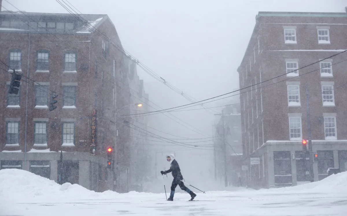 Lisetta Shah cross-country skis on Commercial Street in Portland, Maine, Tuesday, Jan 27, 2015, during a winter storm in downtown Portland, Maine. "I'll probably never get another chance to ski in the city," she said, explaining why she was outing the blizzard. Forecasters with the National Weather Service in Gray have said that much of southern Maine will see 12 to 18 inches of snow, while small bands of intense snowfall will increase those totals in localized areas. (AP Photo/Robert F. Bukaty)