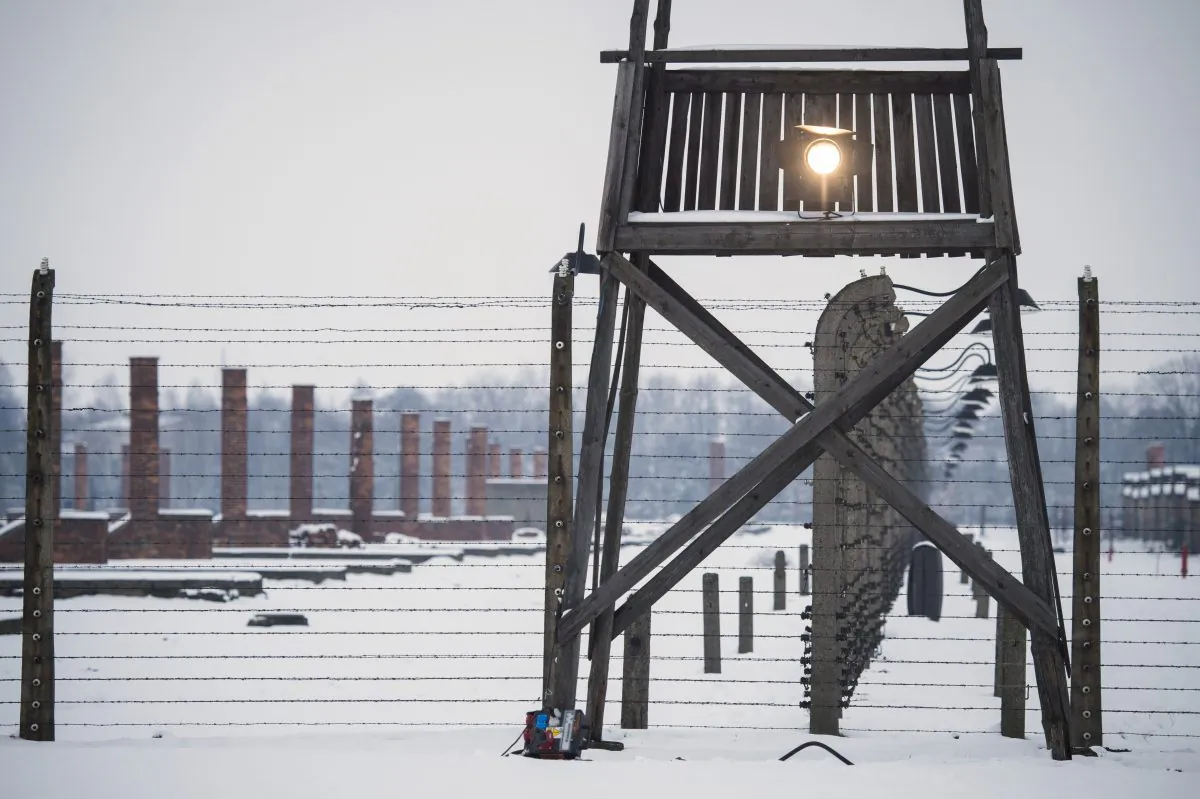 A watch tower stands along a barbed wire fence at the memorial site of the former Auschwitz-Birkenau concentration camp on the eve of the 70th anniversary of the liberation of the Nazi death camp in Oswiecim, Poland, on Jan. 26, 2015. (Odd Andersen/AFP/Getty Images)